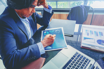 Bad investment or economic crisis concept. Senior businessman is disappointed by business results report.