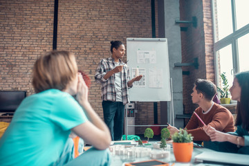 Couple of students standing near board and sharing ideas about project