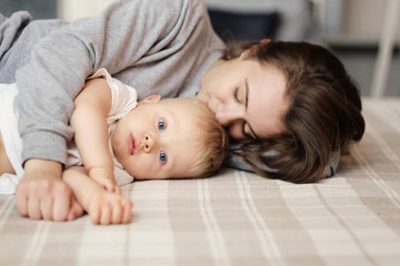 mother and child on bed, mum kiss her son