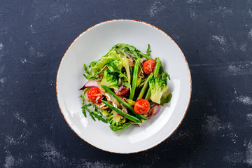 Fresh broccoli salad with cherry tomatoes mix and arugula