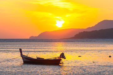 beautiful golden sunrise above fishing boats in Rawai sea Phuket Thailand.