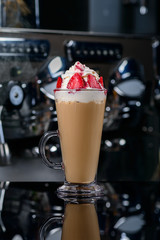 Iced coffee with milk and whipped cream and strawberries