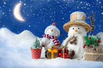 Snowman in a snowdrift with gifts for Christmas and New year