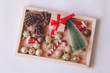 Set of Christmas decoration and gift in wooden box. Holiday concept. Flat lay. Top view.