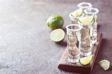 Mexican Gold Tequila with lime and salt on black background with copyspace.