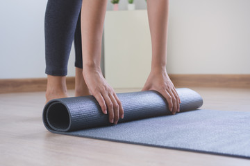 Healthy and wellness lifestyles concept. Woman prepare yoga mat to meditation.