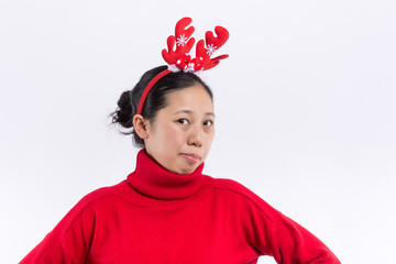 Funny young Santa girl in Christmas hat keeping mouth wide open, jumping spreading hands and legs...