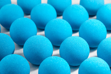 Blue bath bombs pattern on white tabletop