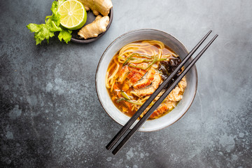 japanese soup with fried eel Yanagawa Nabe in a bowl on gray background, top view