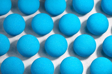 Blue bath bombs pattern on white tabletop