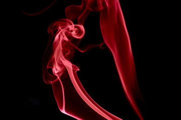 REDDISH SMOKE AGAINST BLACK BACKGROUND