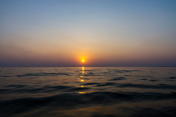 Sunset sky reflection on the water at the lake.