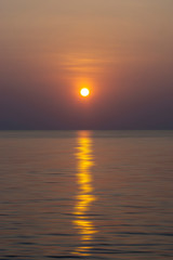 Fototapeta na wymiar Sunset sky reflection on the water at the lake.