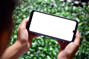 Hand holding blank screen smartphone vertical, gaming gesture on phone