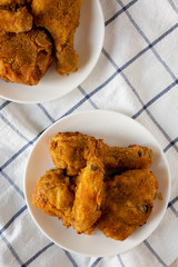 Tasty homemade oven baked fried chicken on a white plate, top view. Overhead, from above, flat lay.