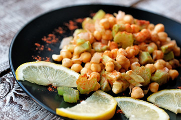 Vegetarian food. Warm sprouted chickpea salad with celery and paprika.