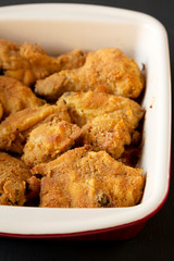 Delicious homemade oven baked fried chicken in a dish, low angle view. Close-up.