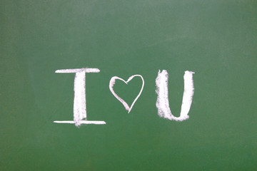 chalk inscription on green blackboard i love you, valentines day concept