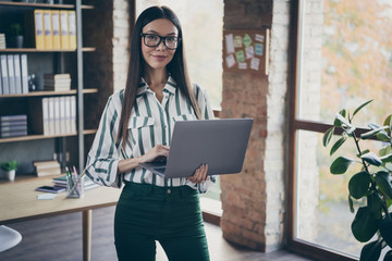 Photo of cheerful joyful girlfriend working as recruiter for a famous corporation listening to employee attentively noting his information down to laptop in green pants - obrazy, fototapety, plakaty