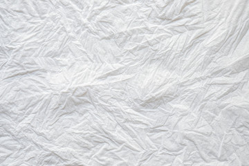 Close-up texture of Crumpled white color tissue paper background abstract. Detail texture of pattern with free space copy for text.