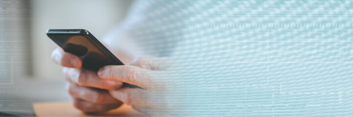 Hands using mobile phone; panoramic banner