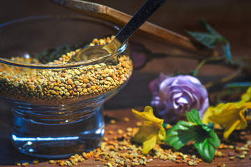 Bee pollen. In a glass container with a spoon