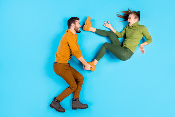 Fototapeta na wymiar Profile side top above high angle view full length body size photo of cheerful positive beautiful spouses with man throwing his girl away playing waiting for her to fall isolated pastel blue color