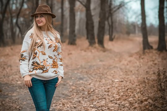 Woman of plus size, American or European appearance walks and enjoying life. A young lady with excess weight, xl size at the park. Natural beauty