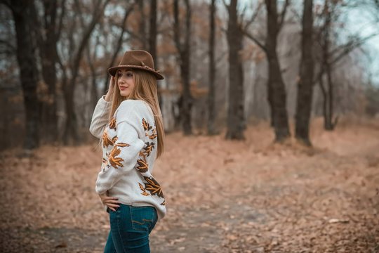 Woman of plus size, American or European appearance walks and enjoying life. A young lady with excess weight, xl size at the park. Natural beauty