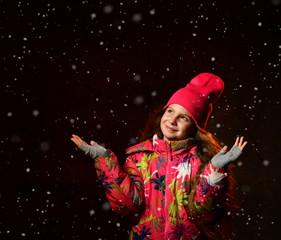 winter, people, happiness concept - woman in hat, muffler and gloves on dark