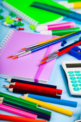 Items for the school on a wooden table.