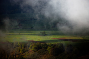 Fototapeta na wymiar Panoramic view of a magical valley in the morning light. Fogy landscape.