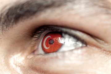 Fototapeta premium Flag of turkey reflects in a man brown eye - election, sport, hope, young, generation 