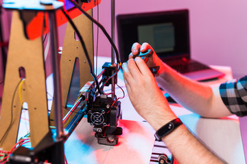 A student man print prototype on 3D printer