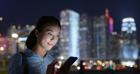 Woman look at mobile phone at night