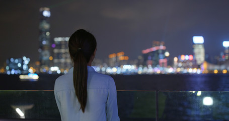 Woman look around the city in Hong Kong at night