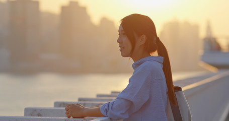 Woman look at the city in sunset