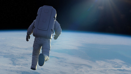 astronaut performing a spacewalk in orbit of the beautiful planet Earth © dottedyeti