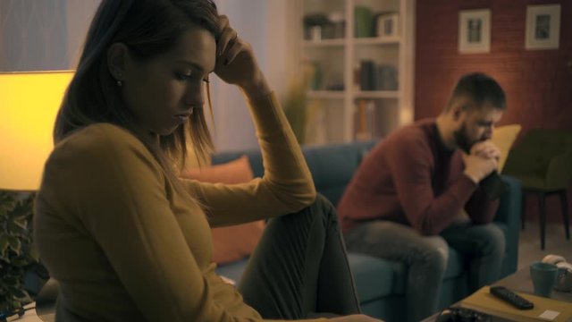 Sad couple at home after having an argument