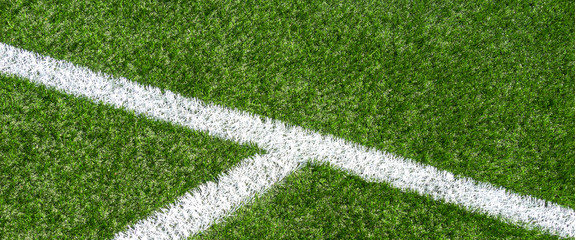 Soccer football sport background. Green synthetic artificial grass soccer sports field with white corner stripe line