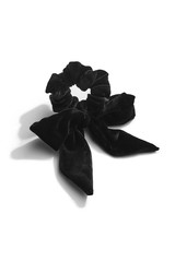 Subject shot of a burgundy velure hair scarf fixed on the scrunchie isolated on the white surface.