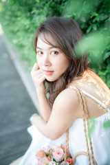 Beautifulk asian women leisure in city public park with sun light