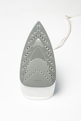 Iron for ironing things on a white isolated background. Laundry concept, tailoring studio, housework