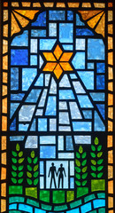 Church stained glass window representing a religious star shining on the union a man and a woman on...