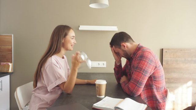 Frustrated man holds his head while his girlfriend chides and berates her partner. Concept of family relations