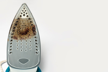 Dirty surface Iron for ironing things on a white isolated background. Concept breakdown or problem, laundry, sewing studio, housework