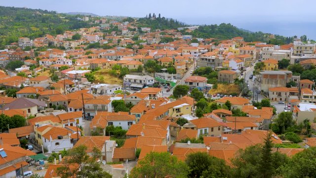 Village in the mountains. Greek old city, down town. Travelling Europe. Top view of white houses with red roofs in Greek city Kymi on Evia, Euboea island, Greece. Beautiful cityscape view