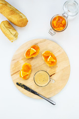 Sandwiches with pumpkin and orange jam on a wooden board.