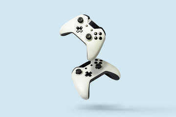 Flying air gamepads from a game console on a blue background. The concept of games, online games, e-sports. Levitation - obrazy, fototapety, plakaty