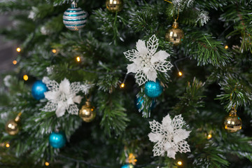 Artificial decorated Christmas tree with balls, ornaments and lights. Festive background for promotion. .